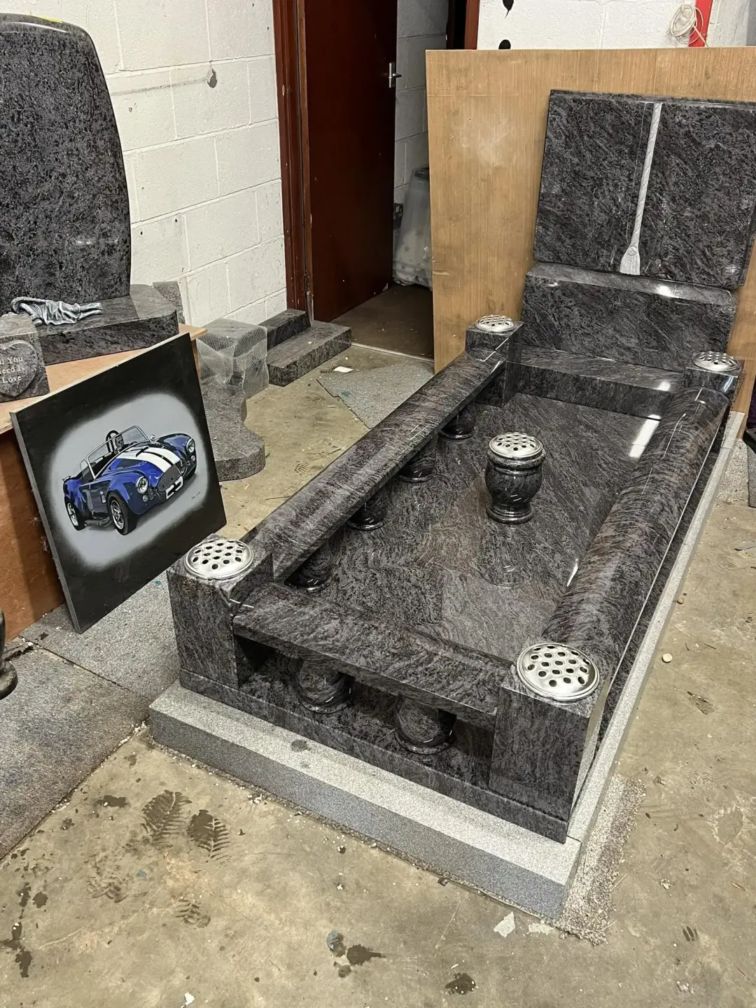 Complete dark-grey granite kerbed memorial prepared in the workshop